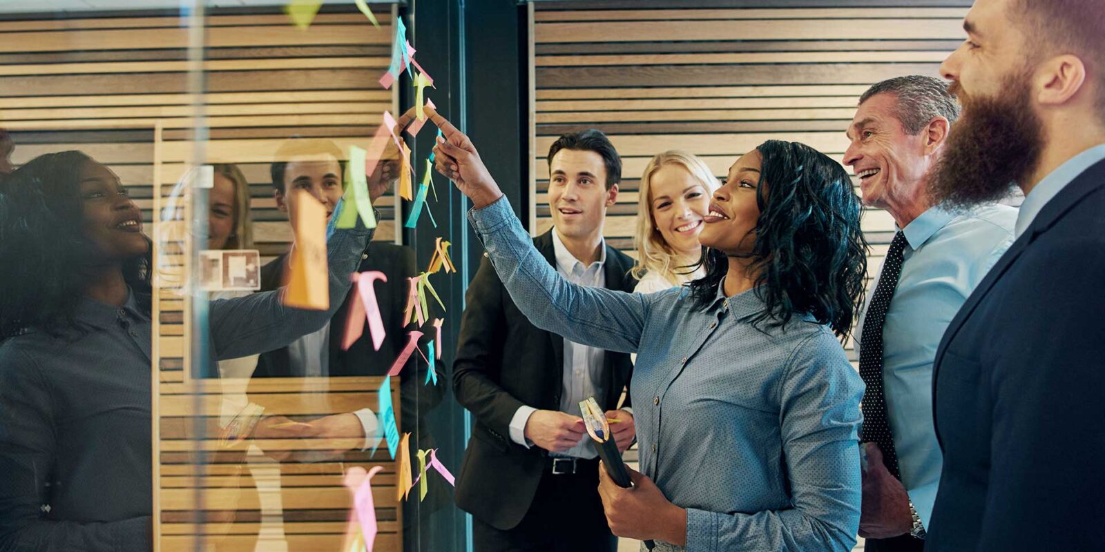 MBA students using post-it notes to outline business notes