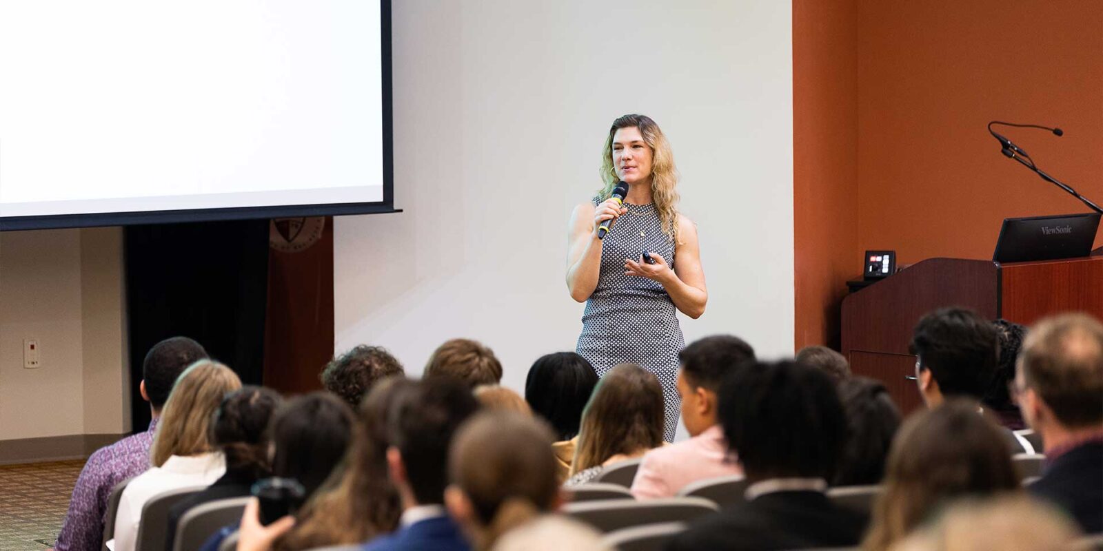 su_ms_organizational_leadership_hero professor speaking in lecture hall